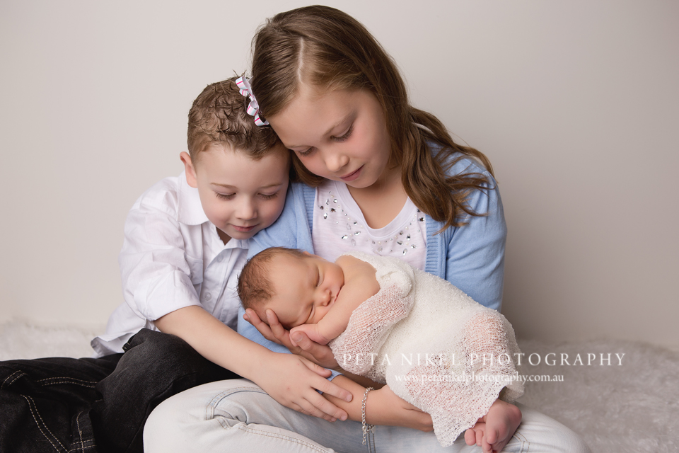 newborn baby portraits with siblings taken in studio in Hobart by Peta Nikel